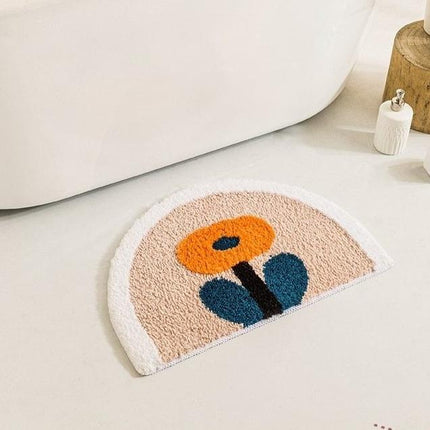 Halvrund badrumsmatta med orange blomma