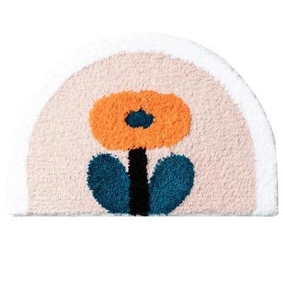 Halvrund badrumsmatta med orange blomma
