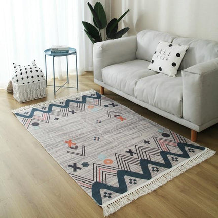 Grå designmatta med orangea detaljer